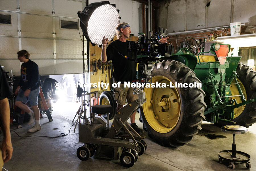 Director of Photography Barry Joyce asks for a light to be adjusted. Filming of the movie using UNL students as the production crew. Richard Endacott earned multiple awards for his screenplay, "Turn Over." Story about keeping the family farm operating in the modern era as two brothers come together via restoring an old tractor to help fund their operations. August 9, 2023. Photo by Craig Chandler / University Communication.