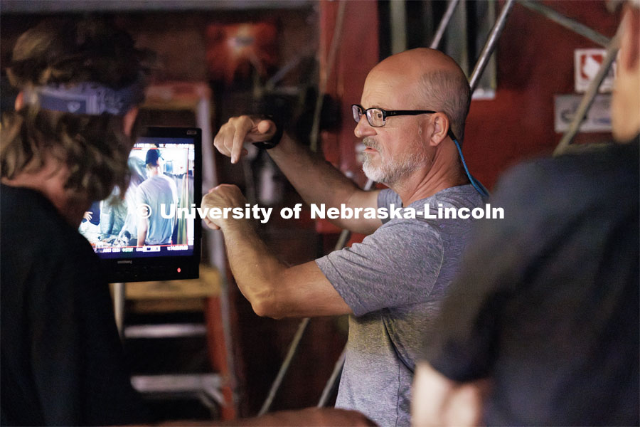Richard Endacott discusses a scene being replayed on the monitor. Filming of the movie using UNL students as the production crew. Richard Endacott earned multiple awards for his screenplay, "Turn Over." Story about keeping the family farm operating in the modern era as two brothers come together via restoring an old tractor to help fund their operations. August 9, 2023. Photo by Craig Chandler / University Communication.
