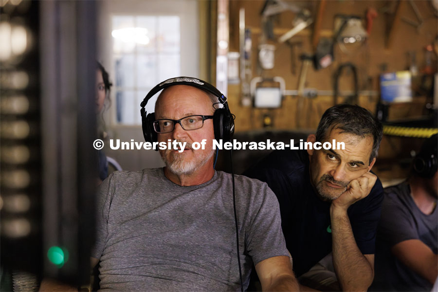 UNL professors Richard Endacott and Steve Kolbe watch the filming on a remote monitor. Filming of the movie using UNL students as the production crew. Richard Endacott earned multiple awards for his screenplay, "Turn Over." Story about keeping the family farm operating in the modern era as two brothers come together via restoring an old tractor to help fund their operations. August 9, 2023. Photo by Craig Chandler / University Communication.