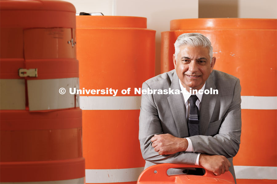 Aemal Khattak, Director of the Mid-America Transportation Center is surrounded by a bunch of traffic cones and barrel barricades. August 11, 2023. Photo by Craig Chandler/ University Communication. 