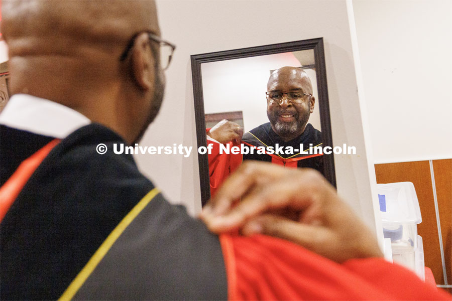 Chancellor Rodney Bennett checks himself in the mirror and adjusts his UNL regalia before the ceremony. The University of Nebraska–Lincoln is conferring 588 degrees during the combined graduate and undergraduate commencement ceremony at Pinnacle Bank Arena. August 12, 2023. Photo by Craig Chandler/ University Communication.