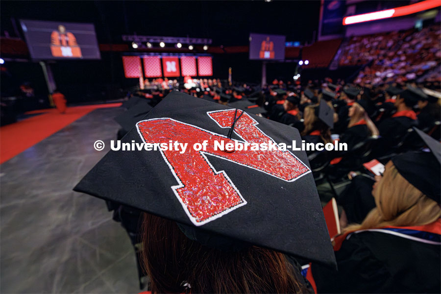 The Nebraska N decorates the top of one grad's mortar board cap. The University of Nebraska–Lincoln is conferring 588 degrees during the combined graduate and undergraduate commencement ceremony at Pinnacle Bank Arena. August 12, 2023. Photo by Craig Chandler/ University Communication.