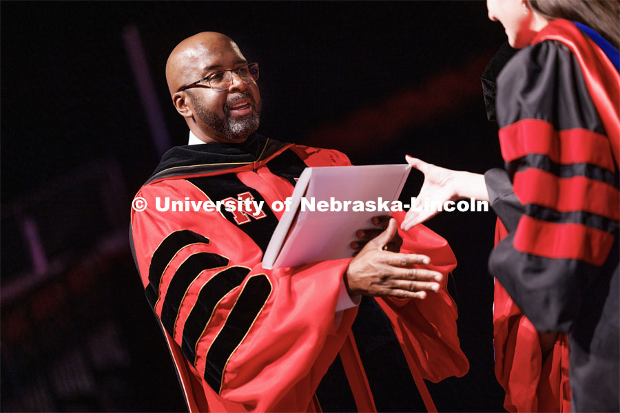 Chancellor Rodney Bennett presents the diplomas to the doctoral and masters degree candidates at the ceremony. The University of Nebraska–Lincoln is conferring 588 degrees during the combined graduate and undergraduate commencement ceremony at Pinnacle Bank Arena. August 12, 2023. Photo by Craig Chandler/ University Communication.