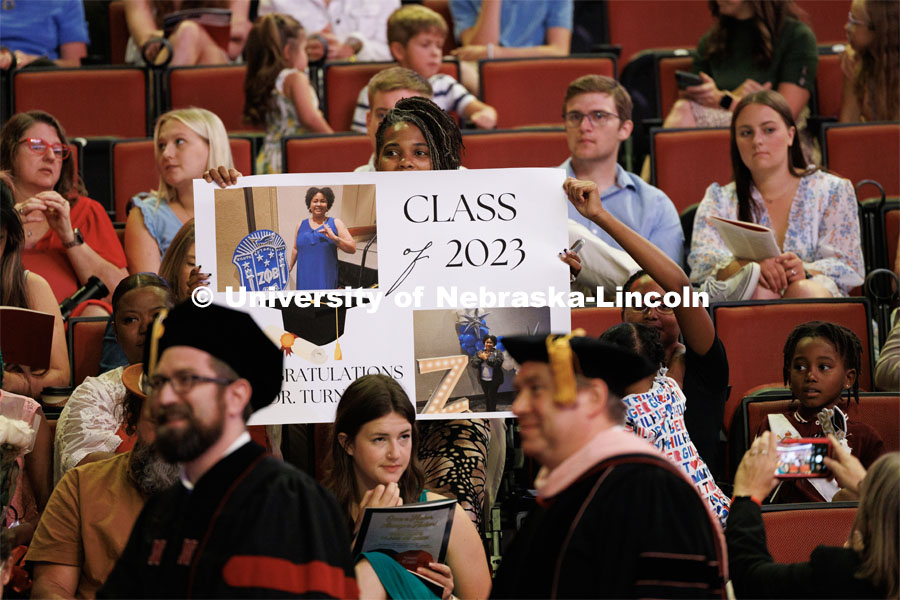 Friends and family of Lequisha Turner hold up posters to celebrate Lequisha receiving her doctoral degree. The University of Nebraska–Lincoln is conferring 588 degrees during the combined graduate and undergraduate commencement ceremony at Pinnacle Bank Arena. August 12, 2023. Photo by Craig Chandler/ University Communication.