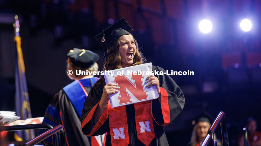 Alexis Martin gestures to family and friends after receiving her College of Education and Human Sciences degree. The University of Nebraska–Lincoln is conferring 588 degrees during the combined graduate and undergraduate commencement ceremony at Pinnacle Bank Arena. August 12, 2023. Photo by Craig Chandler/ University Communication.