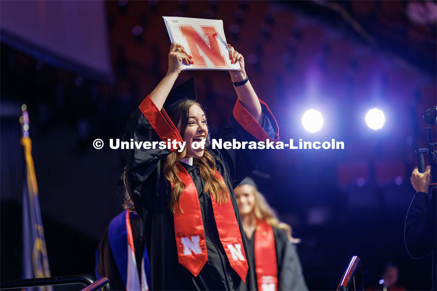 Alyssandra Niemeier gestures to family and friends after receiving her College of Education and Human Sciences degree. The University of Nebraska–Lincoln is conferring 588 degrees during the combined graduate and undergraduate commencement ceremony at Pinnacle Bank Arena. August 12, 2023. Photo by Craig Chandler/ University Communication.