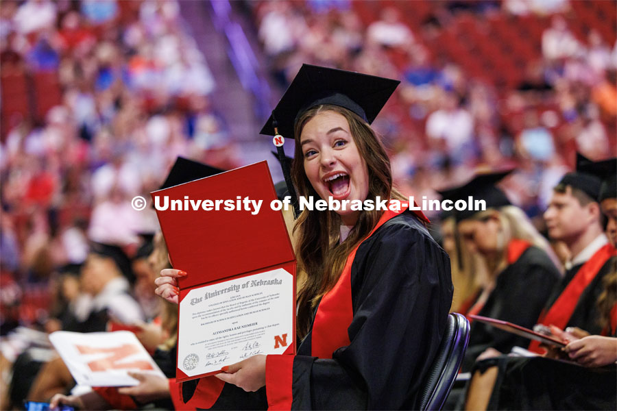 Alyssandra Niemeier shows off her College of Education and Human Sciences degree to her family and friends. The University of Nebraska–Lincoln is conferring 588 degrees during the combined graduate and undergraduate commencement ceremony at Pinnacle Bank Arena. August 12, 2023. Photo by Craig Chandler/ University Communication.
