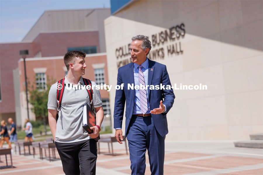 Jack Kinney of Omaha with Richard Moberly, dean of the College of Law, was one of the first Huskers to declare the new interdisciplinary business and law major. Only offered by a handful of business schools, the new major addresses a critical shortage of mid- and upper-level managers with legal knowledge. Kinney and Dean Moberly are pictured walking outside Hawks Hall. August 12, 2023. Photo by Craig Chandler / University Communication and Marketing.