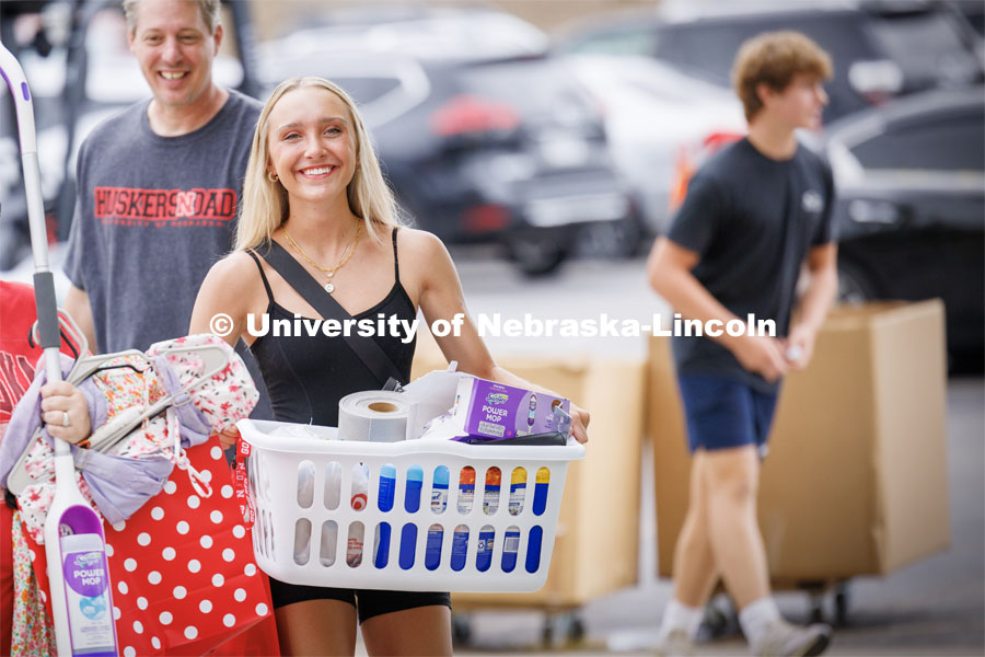 Carley Schroeder of Omaha carries the last of her belongings into Smith Hall. Sunday early arrival move-in for sorority rush. August 13, 2023. Photo by Craig Chandler / University Communication.