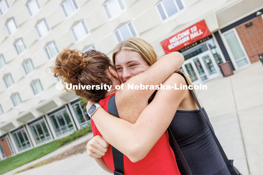 Brielle Staines of Overland Park, Kansas, hugs her mom, Stephanie, outside Schramm Hall. Sunday early arrival move-in for sorority rush. August 13, 2023. Photo by Craig Chandler / University Communication.