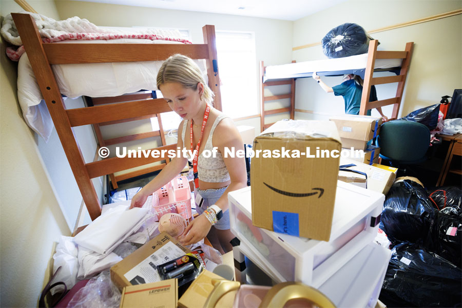 Sydney Perkins of Chaska, Minnesota, unpacks her room in University Suites. Sunday early arrival move-in for sorority rush. August 13, 2023. Photo by Craig Chandler / University Communication.