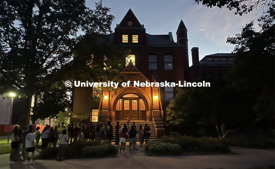A group of students gathers at Architecture Hall to learn some of the history of the oldest building on campus. Big Red Welcome Night Tour. August 15, 2023. Photo by Deann Gayman / University Communication.