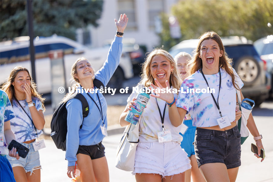 Maddie Kirk and Sophie Ackerman wave as they walk to the next event. Sorority Recruitment. August 15, 2023. Photo by Craig Chandler/ University Communication.
