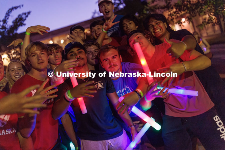 Decked out with glow sticks, students dance at the Block party at Harper Schramm Smith. August 17, 2023. Photo by Craig Chandler / University Communication.