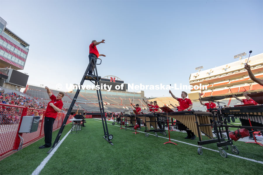 Director of the Cornhusker Marching Band, Anthony Falcone, stands high on the ladder overlooking the band. Big Red Welcome week featured the Cornhusker Marching Band Exhibition in Memorial Stadium where they showed highlights of what the band has been working on during their pre-season Band Camp, including their famous “drill down”. August 18, 2023. Photo by Sammy Smith / University Communication.