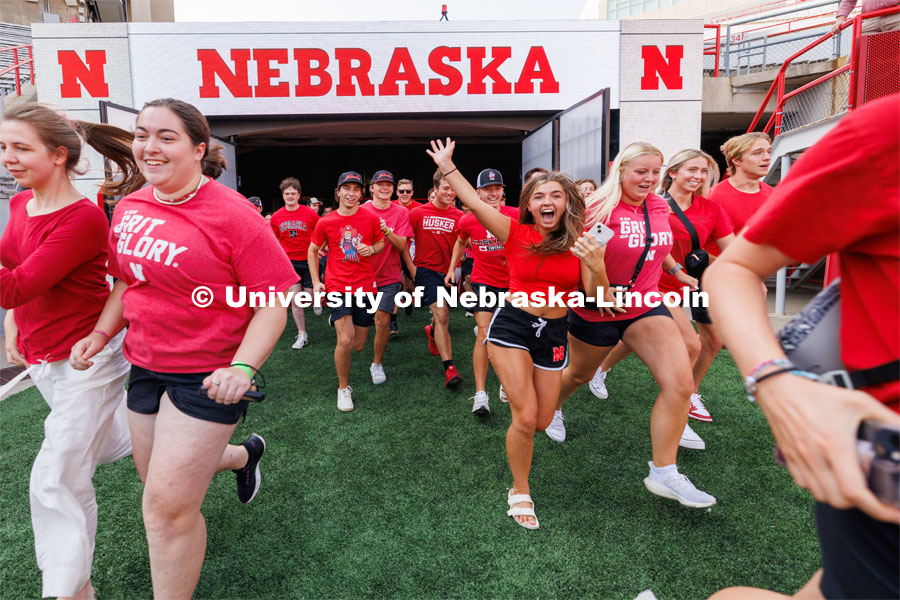 Students charge out of the gates at the Tunnel Walk. Tunnel Walk in Memorial Stadium. August 18, 2023. Photo by Craig Chandler / University Communication.