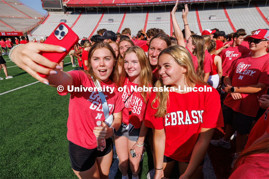 Students pose for a selfie at the Tunnel Walk in Memorial Stadium. August 18, 2023. Photo by Craig Chandler / University Communication.