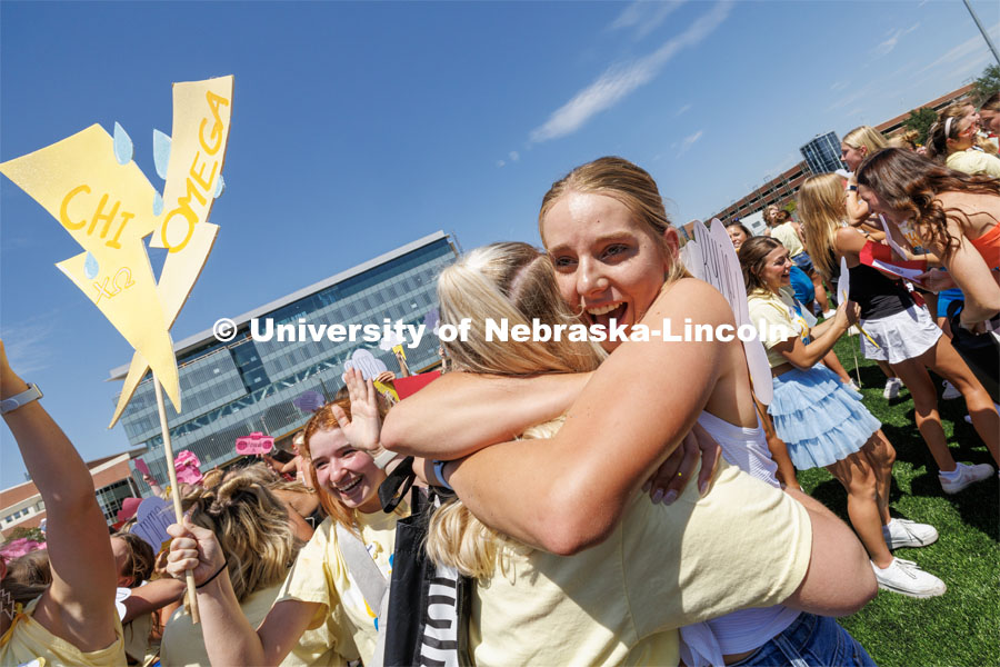 Kylie Lancaster, one of the newest members of the Chi Omega sorority receives a welcoming hug. Sorority Bid Day in the Cather Dining Complex and on the Vine Street Fields. August 19, 2023. Photo by Craig Chandler / University Communication.