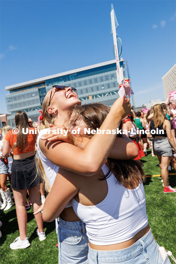 Ava Flood, right, greets her Alpha Phi big sister Izzy Jarecki. Sorority Bid Day in the Cather Dining Complex and on the Vine Street Fields. August 19, 2023. Photo by Craig Chandler / University Communication.
