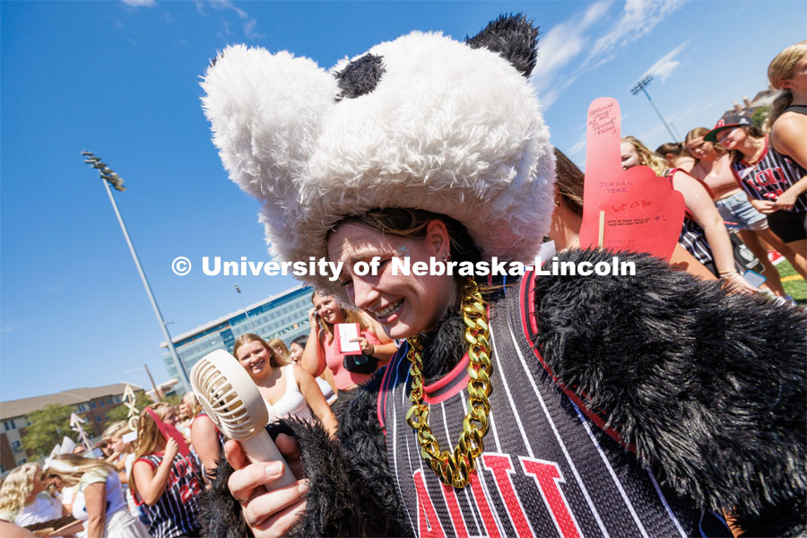 Elsie McCabe, a senior from Omaha, cools off after wearing a panda costume as part of her Alpha Omicron Pi group greeting their new members on the Vine Street Fields. Sorority Bid Day in the Cather Dining Complex and on the Vine Street Fields. August 19, 2023. Photo by Craig Chandler / University Communication.