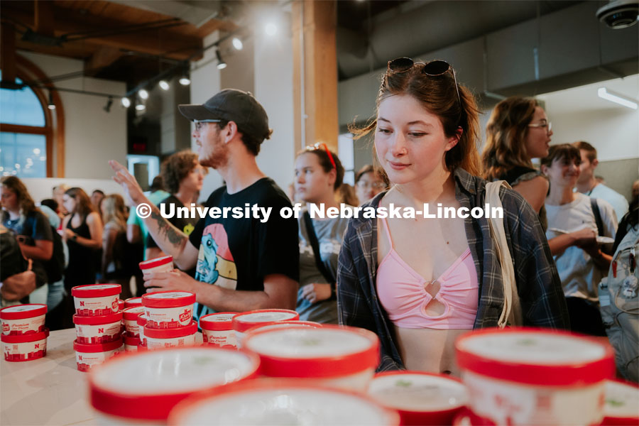 Students decide which flavor ice cream to choose at the ice cream social in Architecture Hall. College of Architecture Welcome Back Social. August 21, 2023. Photo by Jonah Tran / University Communication.