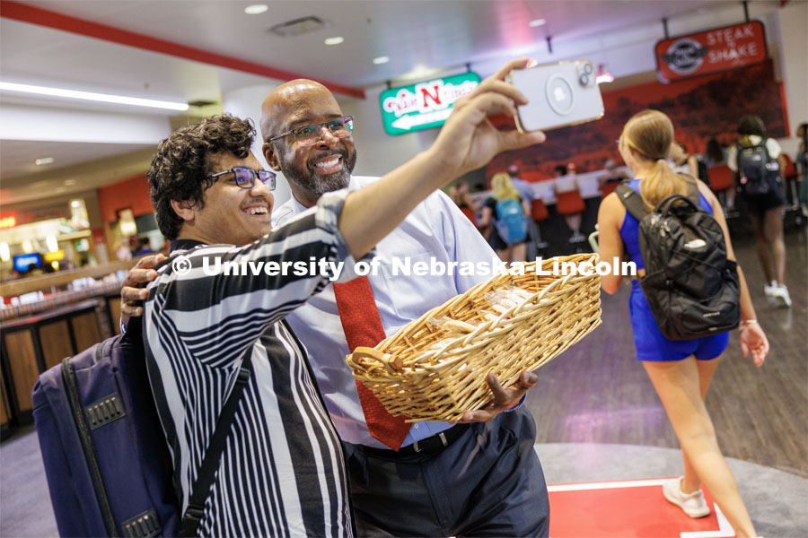 Chancellor Rodney Bennett poses with Rashedul Hasan during the chancellor’s cookie giveaway in the Nebraska Union. First day of classes for fall semester.