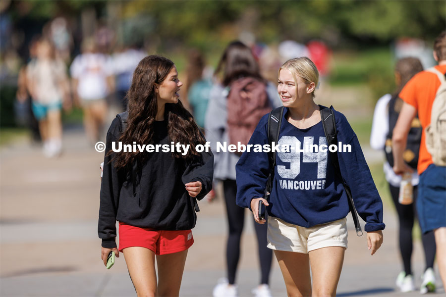 Freshman Julianne Feddema and Brielle Schwartz, both from Minnesota, walk through campus after their 9:30 a.m. class. Students pass between classes on city campus. August 29, 2023. Photo by Craig Chandler/ University Communication.