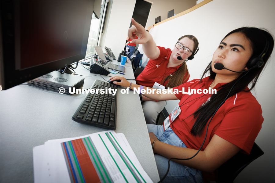 Melanie Gentrup works with Grace Malcolm, a freshman from Falls City, Nebraska, and a sports intern with the Huskers. Gentrup works for the Huskers making sure the graphics are shown properly on the stadium scoreboard. Volleyball Day in Nebraska. August 30, 2023. Photo by Craig Chandler / University Communication.