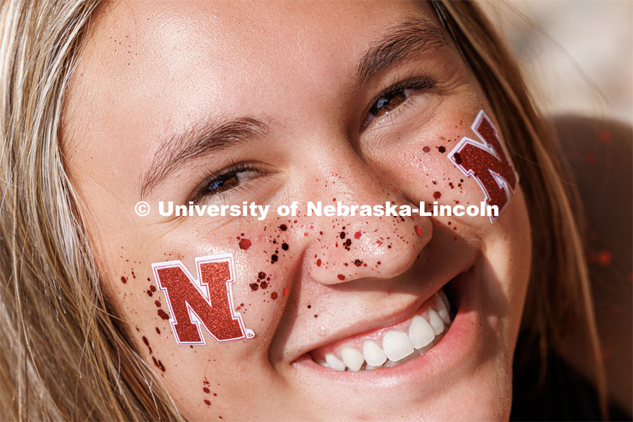 Isabel Molina, a freshman from Wisconsin, sparkles as she waits in line to enter the stadium. Volleyball Day in Nebraska. Husker Nation stole the show on Volleyball Day in Nebraska. The announced crowd of 92,003 surpassed the previous world record crowd for a women’s sporting event of 91,648 fans at a 2022 soccer match between Barcelona and Wolfsburg. Nebraska also drew the largest crowd in the 100-year history of Memorial Stadium for Wednesday’s match. August 30, 2023. Photo by Craig Chandler / University Communication.