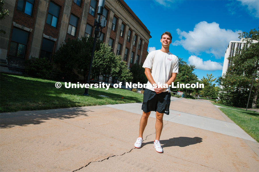 James Jura holds an “I’m a Husker &” sign. Jura is a junior biochemistry major and peer educator with the Center for Advocacy, Response, and Education (CARE). September 6, 2023. Photo by Matthew Strasburger / University Communication.