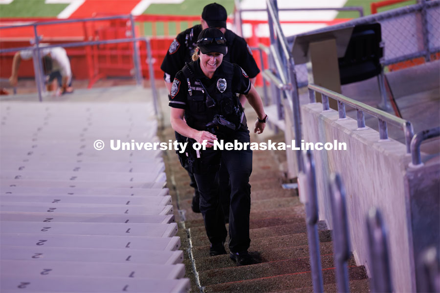 UNLPD officers climb the stairs in Memorial Stadium. University of Nebraska-Lincoln ROTC cadets and midshipmen and Lincoln-area first responders participated in a memorial stair climb, running 2,000-plus stairs, the same total first responders faced 22 years ago. September 11, 2023. Photo by Craig Chandler / University Communication.