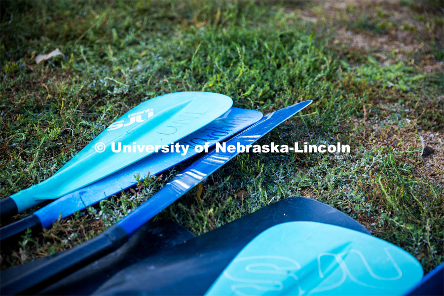 UNL Campus Rec Center’s Paddleboard oars lay in the grass at Branched Oak Lake. About Lincoln - Paddleboarding at Branched Oak Lake with Campus Rec. September 13, 2023. Photo by Kristen Labadie / University Communication.