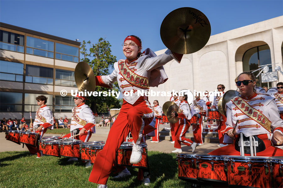 Skyler Krull performs with the cymbals during the battery percussion warm-up on Sheldon Museum of Art west steps. Northern Illinois football in Memorial Stadium. September 16, 2023. Photo by Craig Chandler / University Communication.