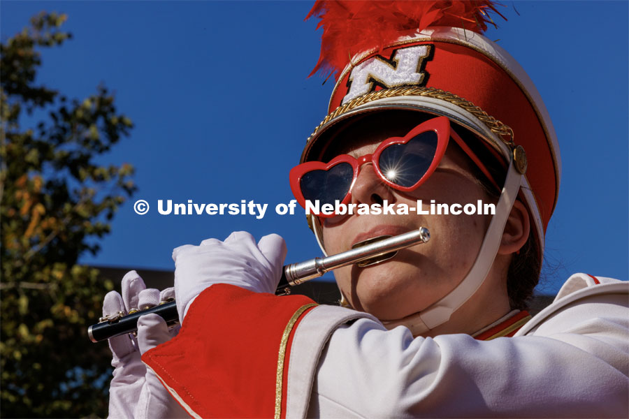 The afternoon sun reflects of Annie Von Kampen’s sunglasses as she and the piccolo section play during the Cornhusker Marching Band warm-up concert on the south side of Woods Art Building. Northern Illinois football in Memorial Stadium. September 16, 2023. Photo by Craig Chandler / University Communication.