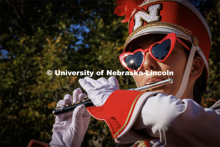 The afternoon sun reflects of Avae Muir’s sunglasses as she and the piccolo section play during the Cornhusker Marching Band warm-up concert on the south side of Woods Art Building. Northern Illinois football in Memorial Stadium. September 16, 2023. Photo by Craig Chandler / University Communication.