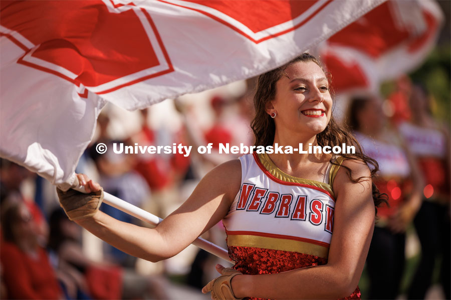 Color guard performs during the Cornhusker Marching Band warm-up concert on the south side of Woods Art Building. Northern Illinois football in Memorial Stadium. September 16, 2023. Photo by Craig Chandler / University Communication.