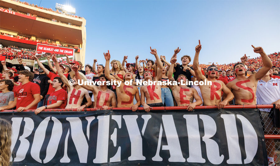 Husker fans in the Boneyard section sing the Scarlet and Cream song. Northern Illinois football in Memorial Stadium. September 16, 2023. Photo by Craig Chandler / University Communication.