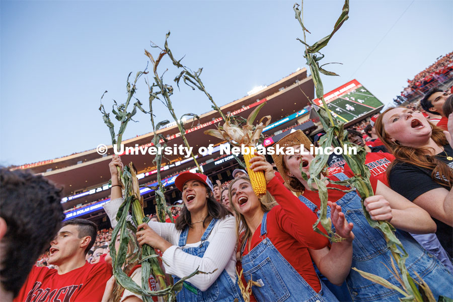 Maggie Norris (red hat), Jaiden Davis and Peyton Kullman go full corn as they cheer on the cornhuskers. Northern Illinois football in Memorial Stadium. September 16, 2023. Photo by Craig Chandler / University Communication.