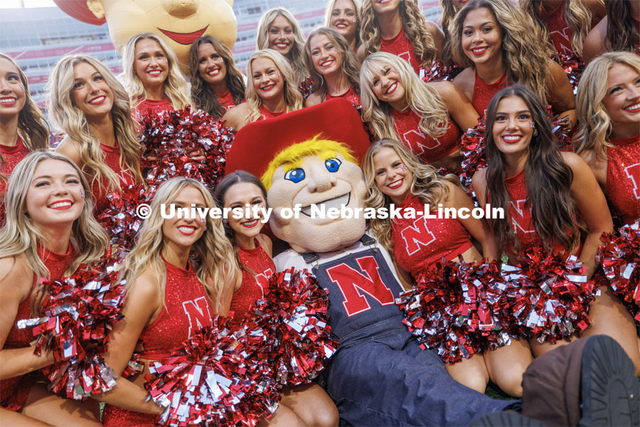 Herbie Husker poses with the Scarlets dance team. Northern Illinois football in Memorial Stadium. September 16, 2023. Photo by Craig Chandler / University Communication.