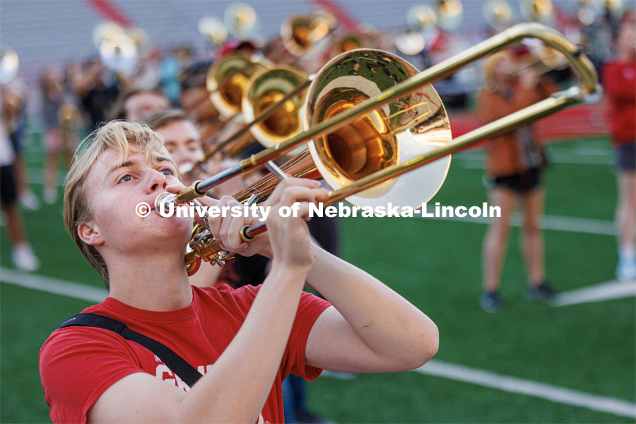Jonah Wemhoff plays his trombone during the Cornhusker Marching Band early morning practice. September 19, 2023. Photo by Craig Chandler / University Communication.