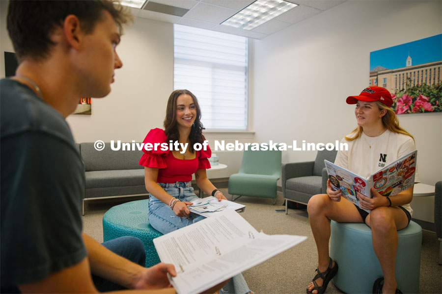 CARE Peer Educators James Jura of St. Joseph, MO, Lydia Storm of Lawrence, KS and Kaitlyn Richards of Ankeny, Iowa discuss hosting Sexual Assault and Relationship Violence Prevention workshops. CARE Peer Educators. September 20, 2023. Photo by Matthew Strasburger / University Communication.