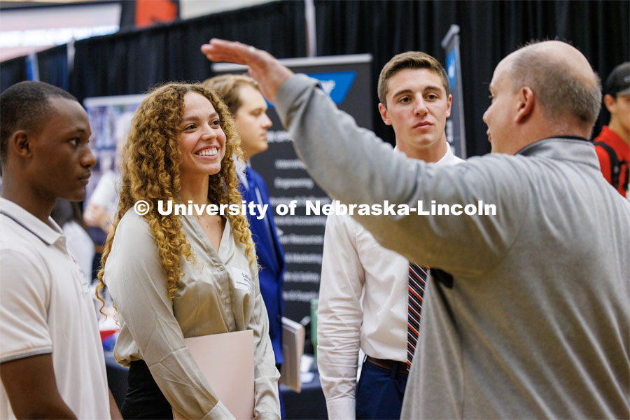 Fernand Kasusa, Lillian Mahaney and Jacob Zitek talk with a recruiter for Kiewit at the Career Fair in the Nebraska Union. September 20, 2023. Photo by Craig Chandler / University Communication.