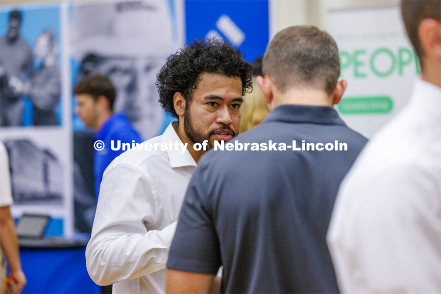 Eldwin Caballero talks with a recruiter for Kiewit at the Career Fair in the Nebraska Union. September 20, 2023. Photo by Craig Chandler / University Communication.