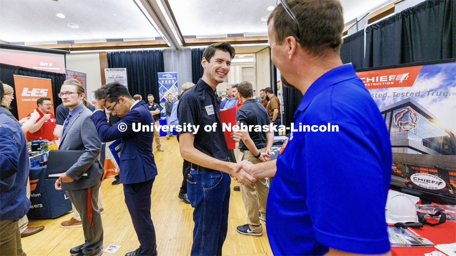 Michael Bates talks with a recruiter for Chief construction at the Career Fair in the Nebraska Union. September 20, 2023. Photo by Craig Chandler / University Communication.