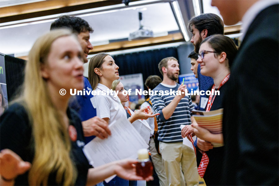 Recruiters including Tessa Yackley, a civil engineer with Olsson who stepped away from her engineering duties to help recruit, line up to talk with students about career opportunities. Career Fair in the Nebraska Union. September 20, 2023. Photo by Craig Chandler / University Communication.