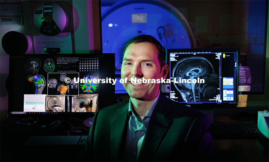 Aron Barbey is backdropped by an fMRI machine at the Center for Brain, Biology and Behavior, which he now directs after recently joining the University of Nebraska–Lincoln. September 22, 2023. Photo by Craig Chandler / University Communication.