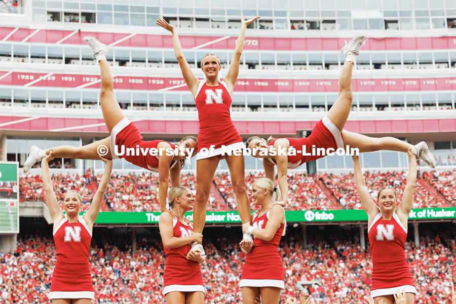 Husker cheer squad lift one another in the air to make a formation. Nebraska football vs. Louisiana Tech. August 23, 2023. Photo by Craig Chandler/ University Communication. 
