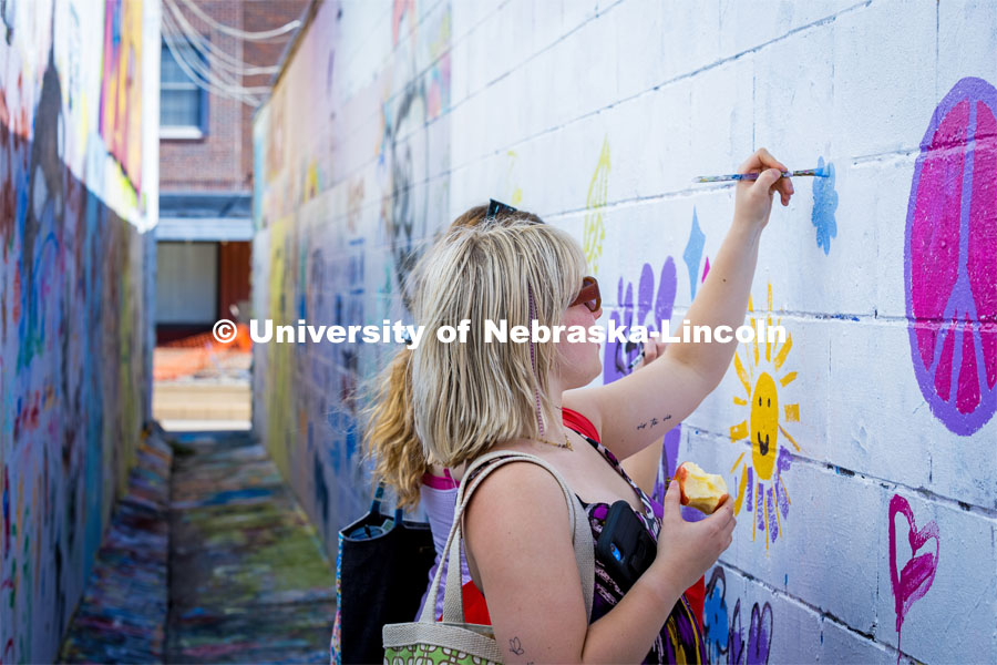 Painting in the art alley at the Lux Street Art Festival. About Lincoln – Lux Street Art Festival. September 24, 2023. Photo by Kristen Labadie / University Communication.