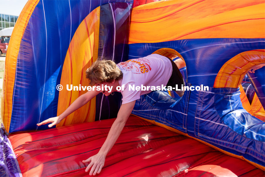 Brady McGerr races through an inflatable obstacle course at Hanging with the Huskers event. September 29, 2023. Photo by Dillon Galloway for University Communications.