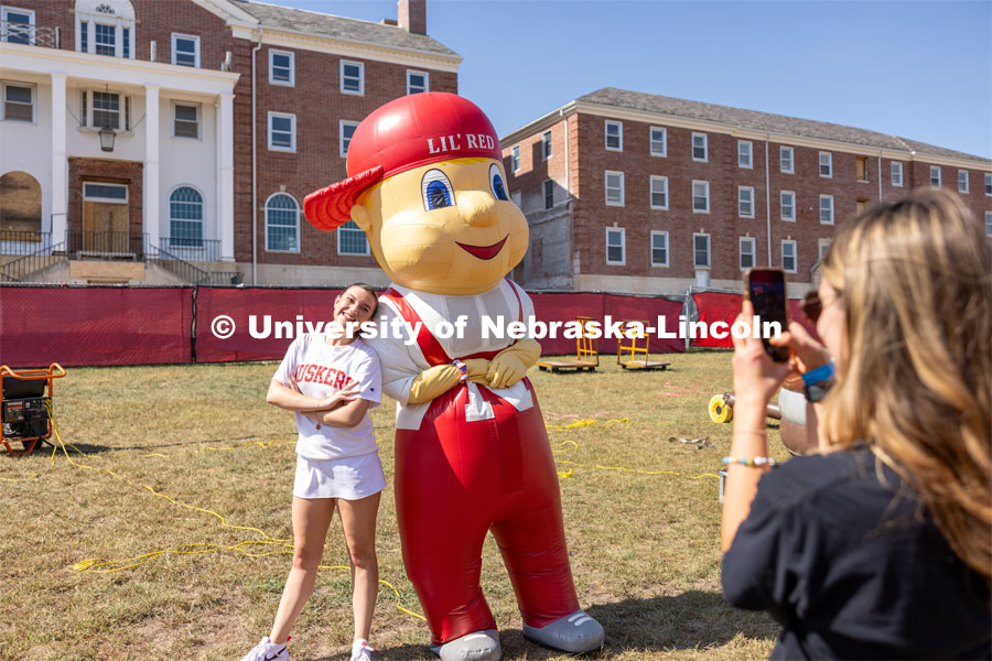 Maddie Ames has friend Meghan McDonald take a picture with Lil Red at Hanging with the Huskers event. September 29, 2023. Photo by Dillon Galloway for University Communications.